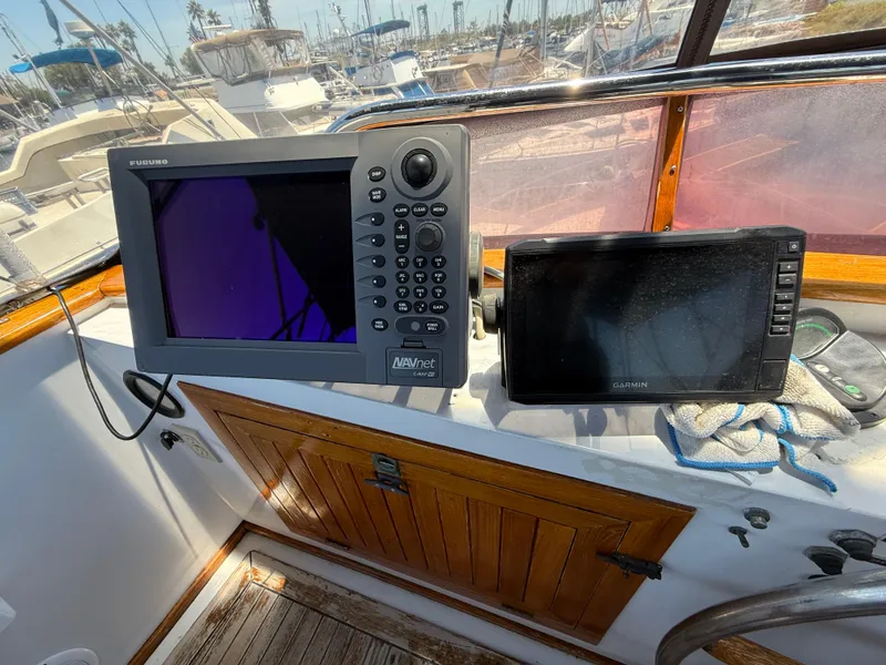 Slide: The Image of Navigation equipment on 1981 DeFever Passagemaker boat, featuring Furuno and Garmin displays. - 10