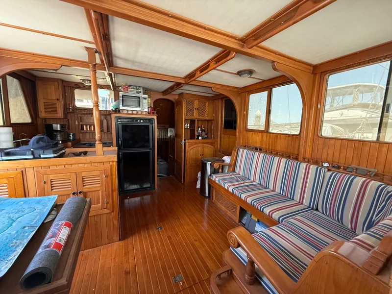 Slide: The Image of 1981 DeFever Passagemaker interior with wood paneling and striped seating. - 13