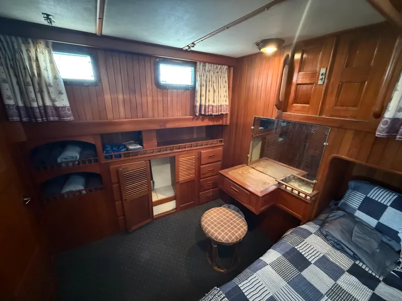 Slide: The Image of 1981 DeFever Passagemaker cabin with wood paneling, bed, and storage. Cozy nautical interior. - 21