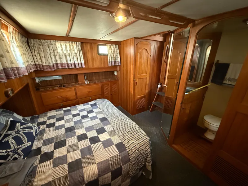 Slide: The Image of Cozy cabin interior of 1981 DeFever Passagemaker with wood paneling and nautical decor. - 22