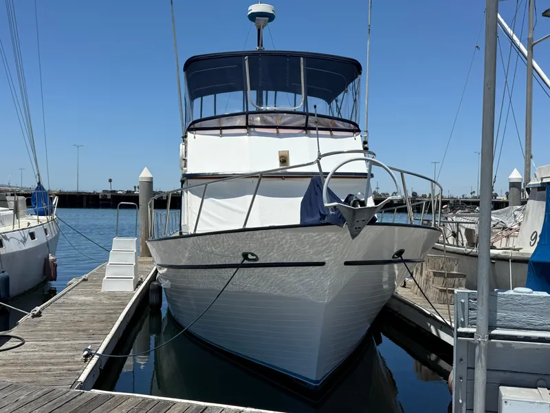 Slide: The Image of 1981 DeFever Passagemaker yacht docked at marina under clear blue sky. - 3