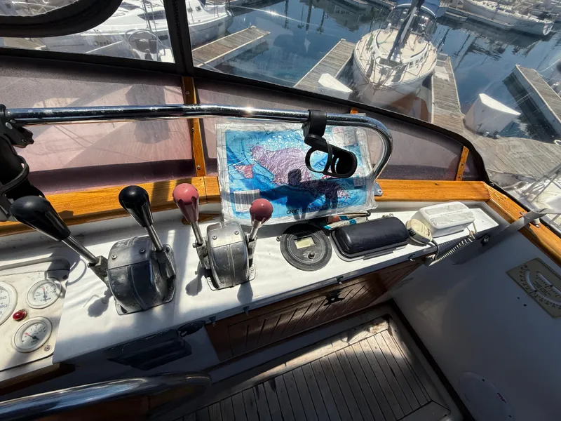 Slide: The Image of 1981 DeFever Passagemaker helm with controls, map, and marina view. - 8