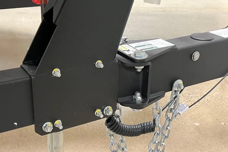 Slide: The Image of Trailer hitch of 2025 Yamaha Boats AR190 with safety chains and bolts. - 14