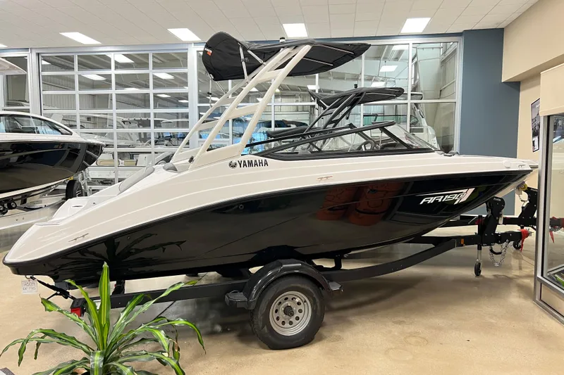 Slide: The Image of 2025 Yamaha Boats AR190 displayed in a showroom, sleek design with black and white finish. - 2