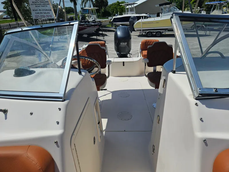 Slide: The Image of 2012 Grady-White Freedom 205 boat interior with seating and outboard motor. - 12