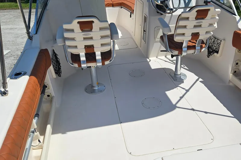 Slide: The Image of 2012 Grady-White Freedom 205 boat interior with seating and steering wheel. - 13