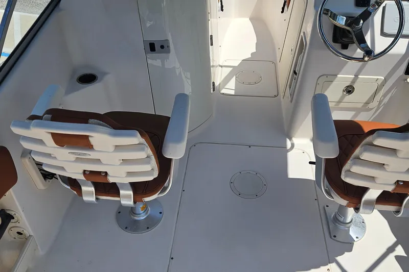 Slide: The Image of 2012 Grady-White Freedom 205 boat interior with dual seats and steering wheel. - 14