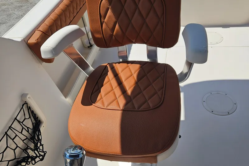 Slide: The Image of Brown cushioned seat on 2012 Grady-White Freedom 205 boat, featuring diamond stitching. - 16