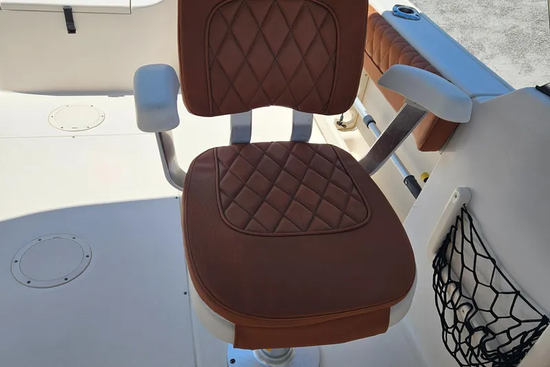 Slide: The Image of Brown cushioned seat on 2012 Grady-White Freedom 205 boat deck. - 17