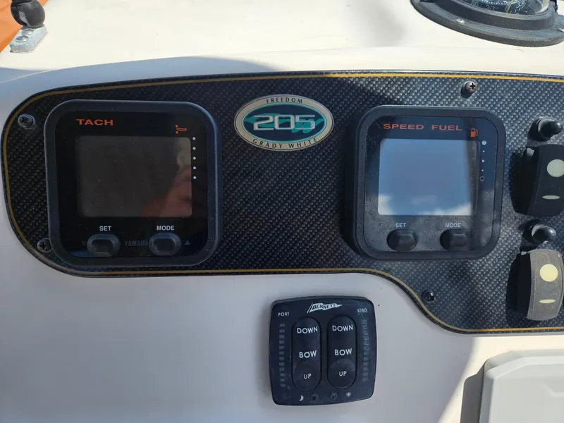 Slide: The Image of Dashboard of a 2012 Grady-White Freedom 205 boat with tachometer and speed fuel gauges. - 18
