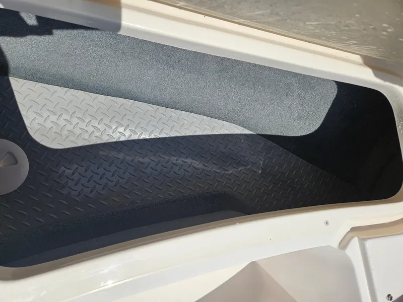 Slide: The Image of Storage compartment of a 2012 Grady-White Freedom 205 boat with textured flooring. - 21