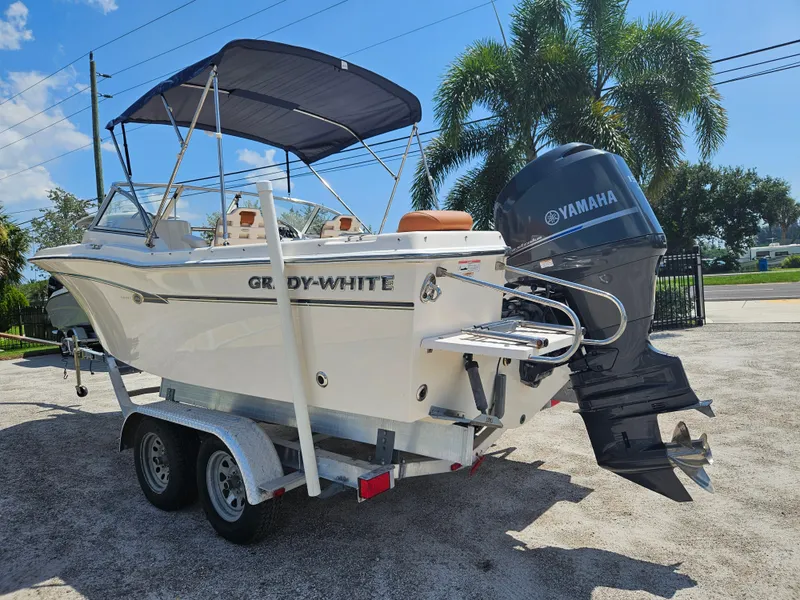 Slide: The Image of 2012 Grady-White Freedom 205 boat with Yamaha engine on trailer, parked outdoors. - 3