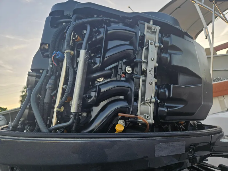 Slide: The Image of Close-up of a 2012 Grady-White Freedom 205 boat engine, showcasing intricate mechanical details. - 30