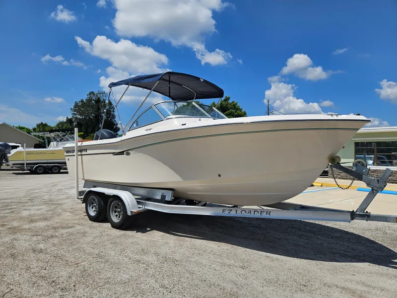 Slide: The Image of 2012 Grady-White Freedom 205 boat on trailer under blue sky. - 5