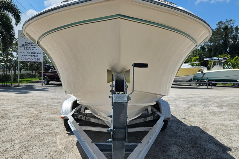 Slide: The Image of 2012 Grady-White Freedom 205 boat on trailer, parked outdoors under clear sky. - 7