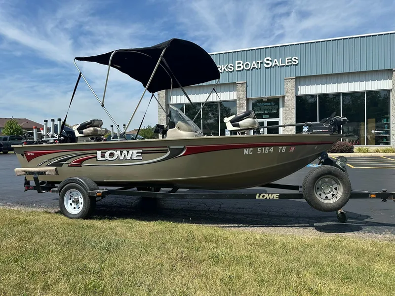 Slide: The Image of 2007 Lowe Fishing Machine FM165S boat on trailer outside dealership. - 0