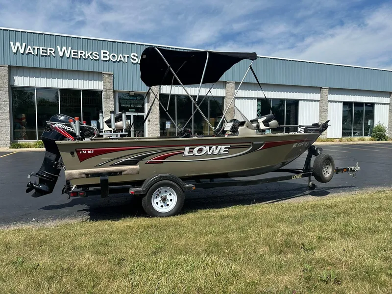 Slide: The Image of 2007 Lowe Fishing Machine FM165S boat on trailer outside Water Werks Boat Sales. - 1