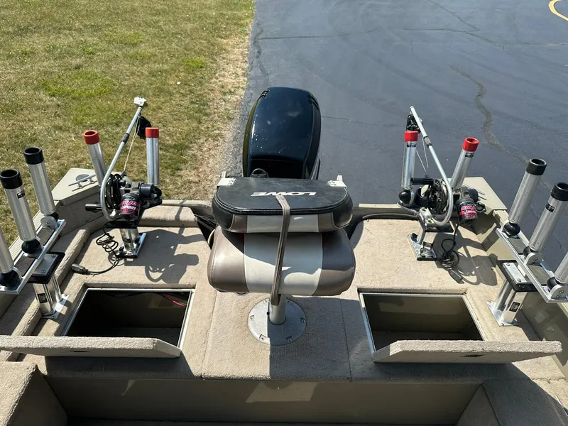 Slide: The Image of 2007 Lowe Fishing Machine FM165S with rod holders and storage compartments on deck. - 10
