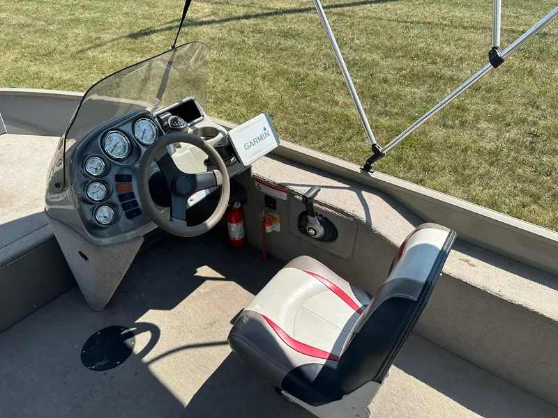 Slide: The Image of 2007 Lowe Fishing Machine FM165S boat cockpit with steering wheel, Garmin GPS, and gauges. - 12