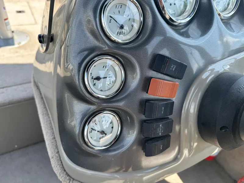 Slide: The Image of Dashboard of 2007 Lowe Fishing Machine FM165S with gauges and switches. - 16