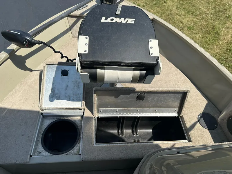 Slide: The Image of 2007 Lowe Fishing Machine FM165S boat interior with storage compartments and seat. - 18