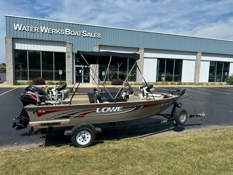 Slide: The Image of 2007 Lowe Fishing Machine FM165S boat outside Water Werks Boat Sales building. - 2