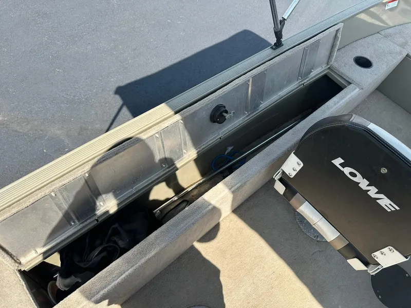Slide: The Image of 2007 Lowe Fishing Machine FM165S boat interior with storage compartment and seat. - 22