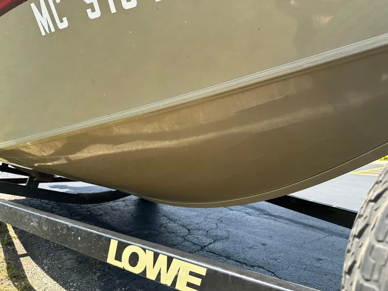 Slide: The Image of 2007 Lowe Fishing Machine FM165S boat on trailer, close-up view. - 27
