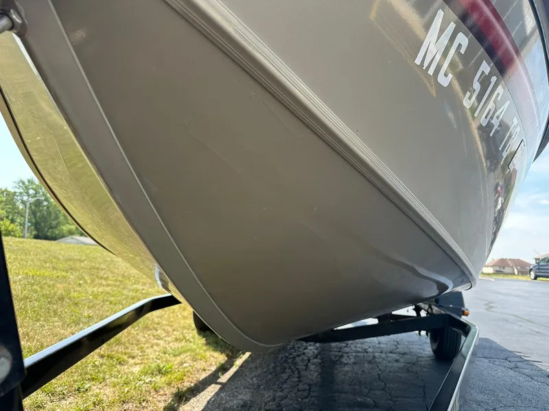 Slide: The Image of 2007 Lowe Fishing Machine FM165S boat on trailer, close-up view. - 28