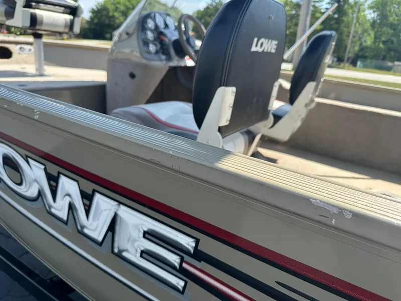 Slide: The Image of 2007 Lowe Fishing Machine FM165S interior with seats and dashboard, showcasing brand logo. - 29