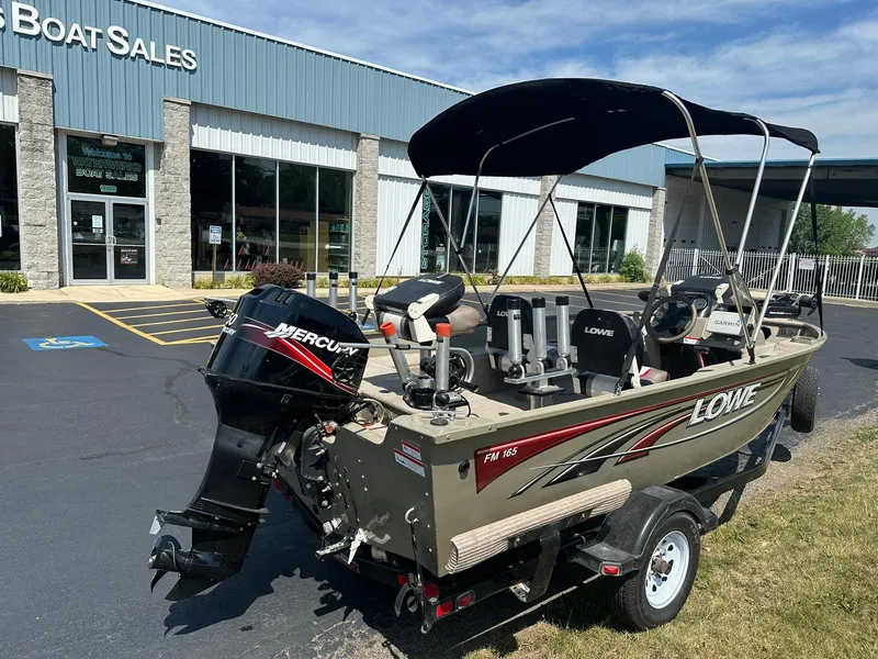 Slide: The Image of 2007 Lowe Fishing Machine FM165S boat with Mercury engine at dealership. - 3