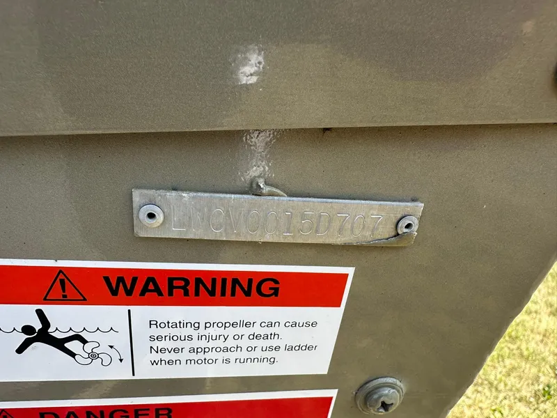 Slide: The Image of 2007 Lowe Fishing Machine FM165S with warning label and serial number plate. - 32