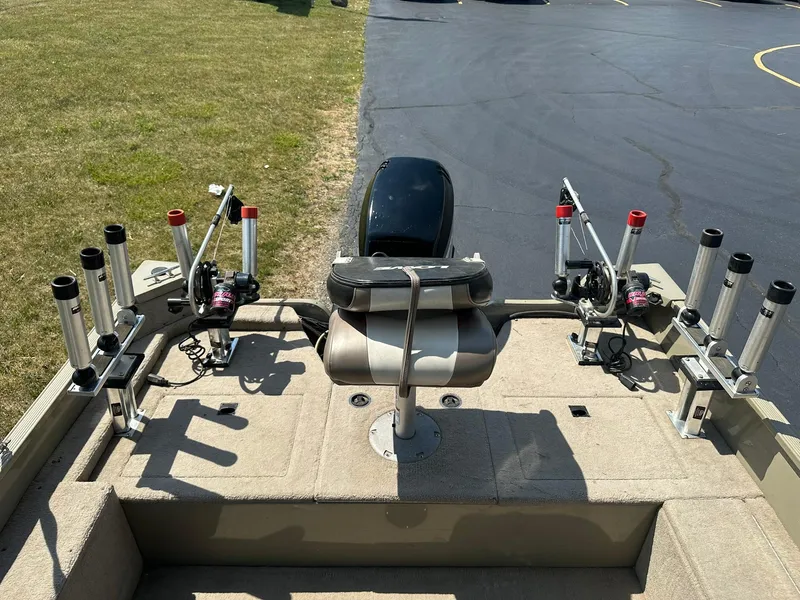 Slide: The Image of 2007 Lowe Fishing Machine FM165S boat with rod holders and seating on a sunny day. - 9