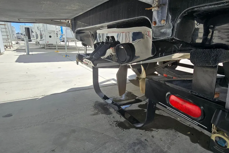 Slide: The Image of Underneath view of a 2007 Supreme V232 boat, showcasing propeller and trailer details. - 26