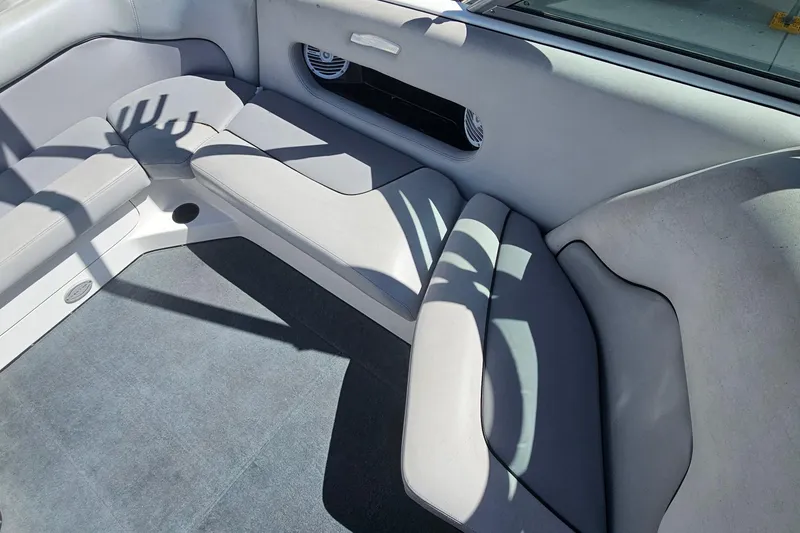Slide: The Image of Interior seating of a 2007 Supreme V232 boat, featuring gray upholstery and carpet. - 33