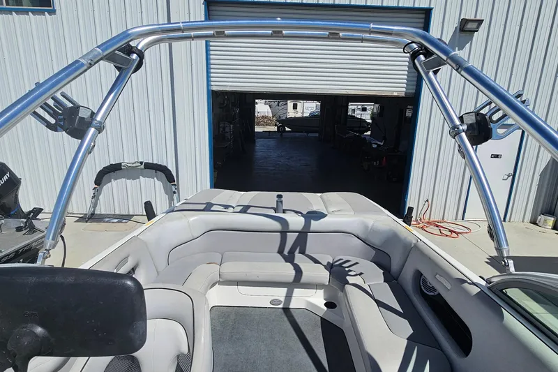 Slide: The Image of 2007 Supreme V232 boat interior with wakeboard tower, parked outside a garage. - 34