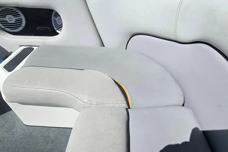 Slide: The Image of Torn upholstery on a 2007 Supreme V232 boat seat with visible speaker. - 35