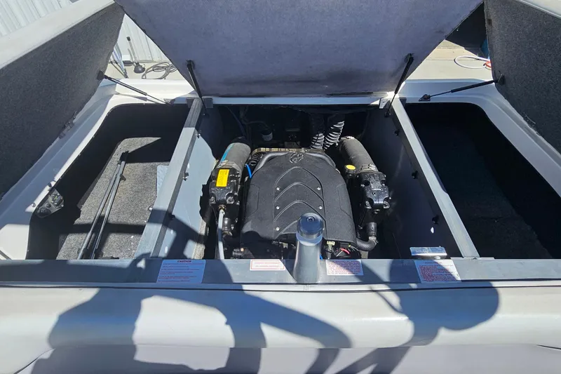 Slide: The Image of Open engine compartment of a 2007 Supreme V232 boat, showcasing the engine details. - 37