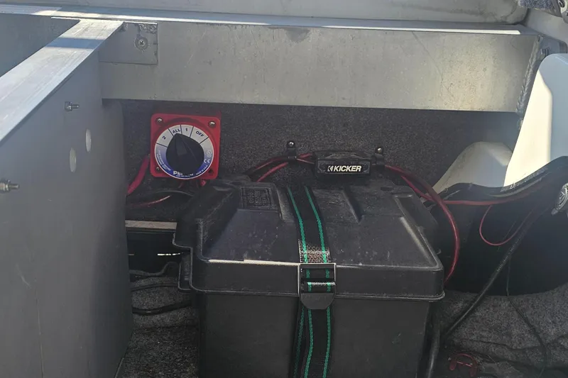 Slide: The Image of Battery compartment of a 2007 Supreme V232 boat with wiring and control panel. - 42