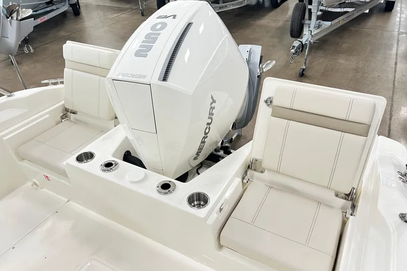 Slide: The Image of 2026 Boston Whaler 220 Dauntless boat with Mercury engine and seating area. - 5