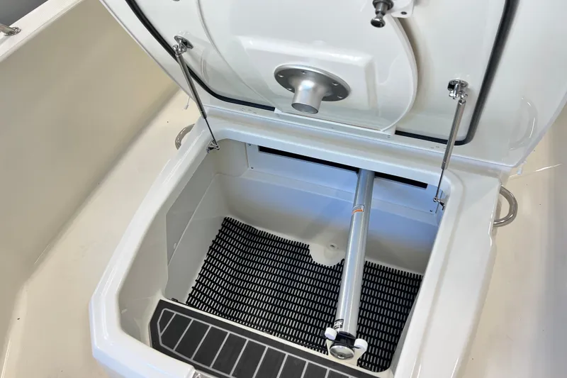 Slide: The Image of 2026 Boston Whaler 220 Dauntless storage compartment with open lid and interior view. - 6