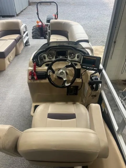 Slide: The Image of 2018 Tracker 22 DLX boat interior with steering console and seating. - 5