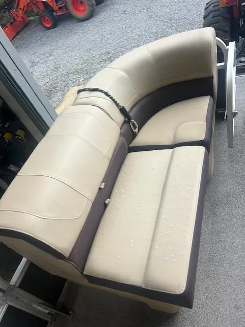 Slide: The Image of Beige and brown boat seat on a 2018 Tracker 22 DLX, with water droplets. - 7