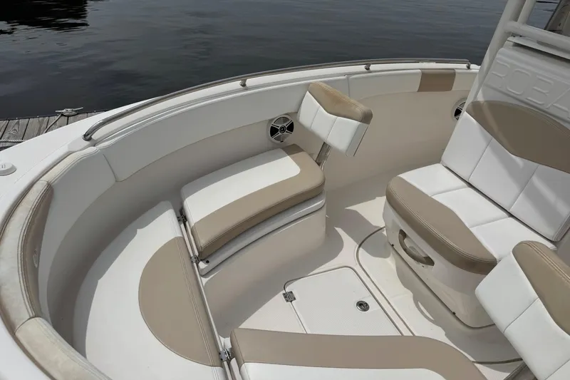 Slide: The Image of 2018 Robalo R222 Explorer boat interior with cushioned seating and storage compartments. - 4