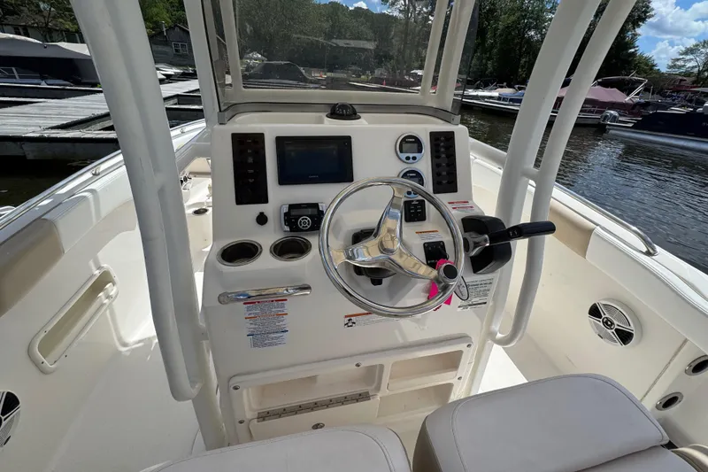 Slide: The Image of 2018 Robalo R222 Explorer boat helm with steering wheel and control panel. - 8
