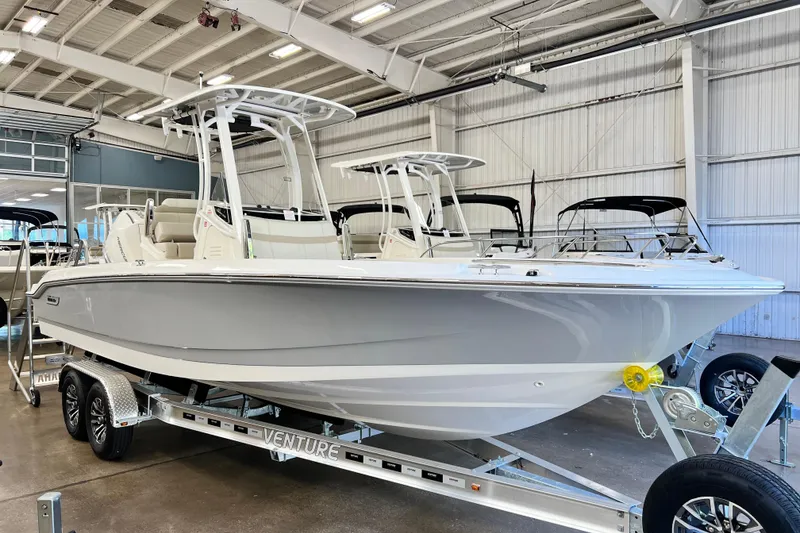 The Image of 2026 Boston Whaler 250 Dauntless boat on trailer in showroom. - 0