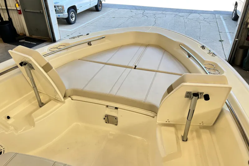 Slide: The Image of 2026 Boston Whaler 250 Dauntless boat interior with cushioned seating and storage compartments. - 12