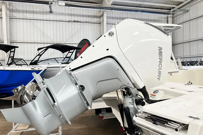 Slide: The Image of 2026 Boston Whaler 250 Dauntless with Mercury outboard engine in showroom. - 3