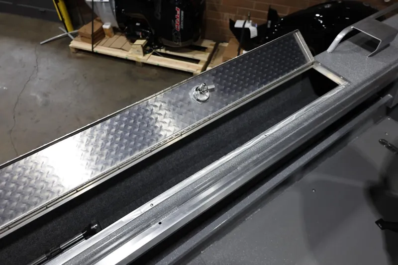 Slide: The Image of Open storage compartment on 2025 Thunder Jet 209 Rush OT boat. - 16