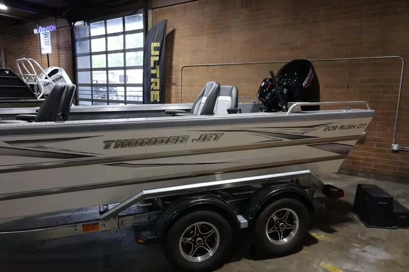 Slide: The Image of 2025 Thunder Jet 209 Rush OT boat on trailer in showroom. - 4